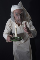 Vertical image of a mature man in old fashioned Victorian night shirt 