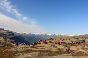 Trolltunga, Norway - August 26, 2017: Many people waiting in a long line to get out on the Trolltunga for their photograph.