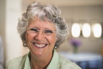 Fototapeta na wymiar Portrait of smiling senior woman wearing eyeglasses