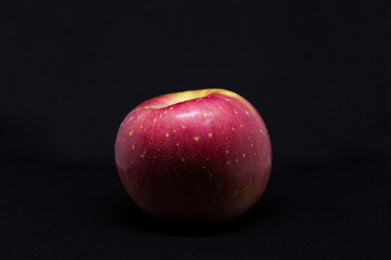 red apple isolated on black bg with luxury tone