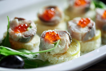 Cropped close up of canapes with fish and red caviar delicious fresh hunger appetite appetizers canape recipe traditional cusine restaurant cafe menu gourmet concept.