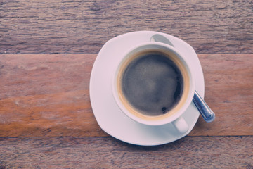 Black coffee on the wood table. (vintage tone)