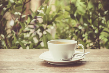 Black coffee on the wood table. (vintage tone)