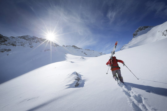 Skier ascending in deep snow, Zugspitze, Upper Bavaria, Germany