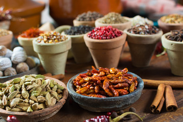 Variety of different asian and middle east spices, colorful assortment, on old wooden table