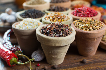 Variety of different asian and middle east spices, colorful assortment, on old wooden table