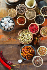 Variety of different asian and middle east spices, colorful assortment, on old wooden table