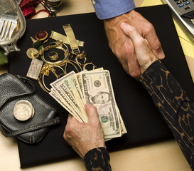 woman selling gold and silver shaking hands receiving cash