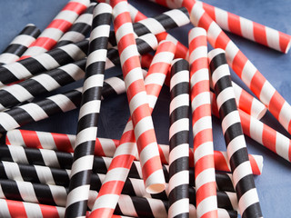 Red and black striped straws background. Party cocktail concept