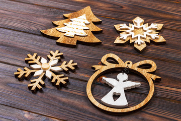 Christmas snowflakes, Christmas tree and angel in a frame on a wooden background. New Year wooden decorations