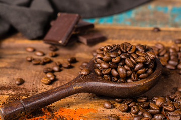 Dark roasted pure arabica coffee beans and ground coffe on the wooden table, copy space