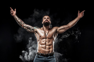 Obraz premium Bodybuilder posing. Beautiful sporty guy male power. Fitness muscled man. Spot concept