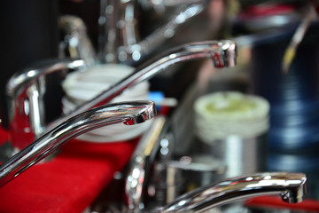 Obraz premium The water tap, faucet for the bathroom and kitchen mixer, in a showroom, . Chrome-plated metal.