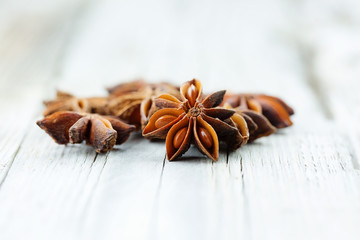 Illicium verum, star anise, staranise, star anise seed, Chinese star anise, or badiam on wooden table. Studio light, selective focus. © Natalie Barth