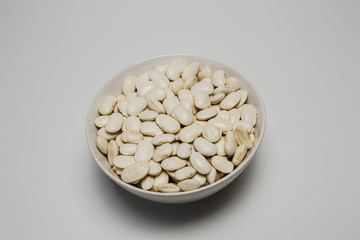 White beans in bowl on white background