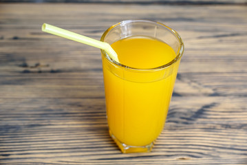 oranges and orange juice on a wooden background