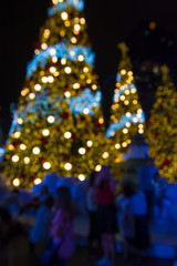 Fototapeta na wymiar abstract blurred background of people walk with christmas lighting