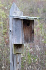 The old wood birdhouse on a close up view.