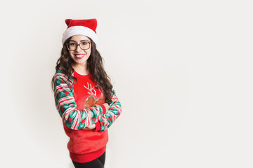 Adorable hispanic woman in Christmas sweater and santa hat