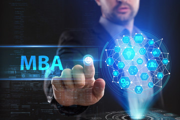 The concept of business, technology, the Internet and the network. A young entrepreneur working on a virtual screen of the future and sees the inscription: MBA