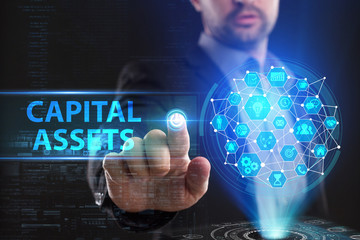 The concept of business, technology, the Internet and the network. A young entrepreneur working on a virtual screen of the future and sees the inscription: Capital assets