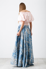 Young girl in blue skirt and pink shirt