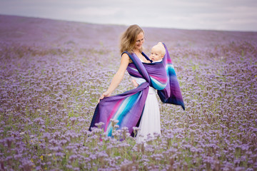 purple bee loving plant phacelia with mther carrying baby in a sling breastfeeding