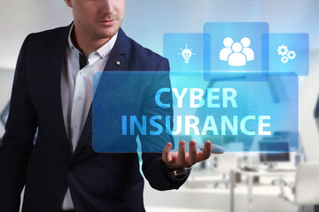 Business, Technology, Internet and network concept. Young businessman working on a virtual screen of the future and sees the inscription: Cyber insurance
