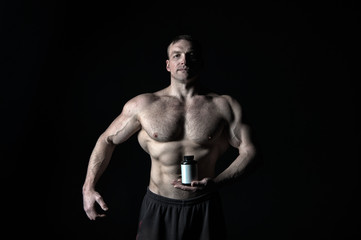 Fototapeta na wymiar Man with muscular body hold pill jar, sport.