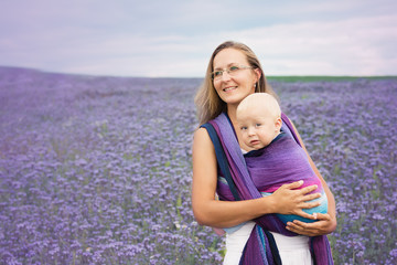 purple bee loving plant phacelia with mther carrying baby in a sling breastfeeding