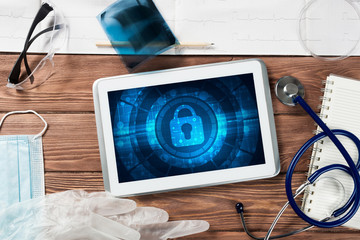 Web security and technology concept with tablet pc on wooden table
