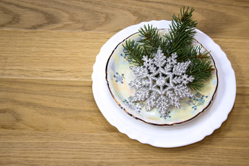 Decor of the festive table. Christmas decor on plates.