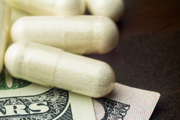Fototapeta na wymiar White capsules of glucosamine chondroitin, healthy supplement pills on wooden table, macro image