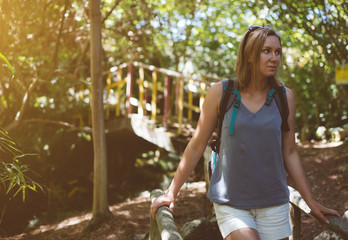 Woman with backpack in the forest.