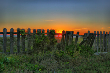 fence sunrise sunset ocean sea tranquil 