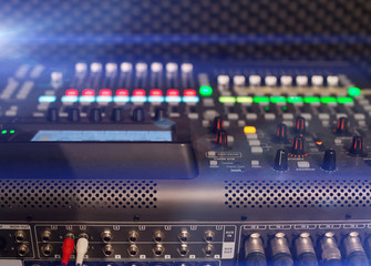 Professional audio mixing console in studio.