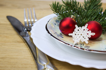 Festive table with Christmas decorations. Plates with festive decor. Close-up.