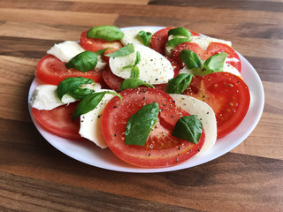 Photo of healthy salad with mozzarella, tomato and basil