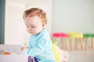 little child is playing with toys in the studio