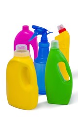 Detergent containers and spray bottle arranged on white