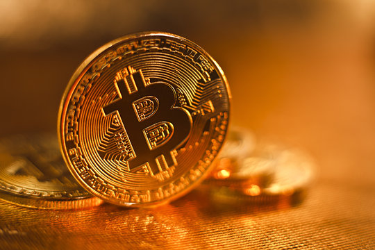 Bitcoin. several coins of bitcoin on a golden background