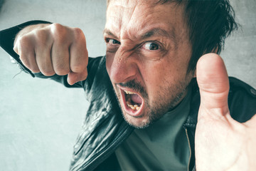 Aggressive man punching with fist, victim's pov