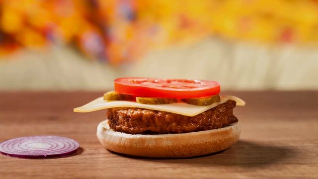 Making a hamburger - sideview of assembling ingredients, stop motion animation