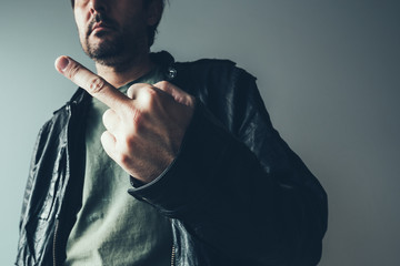 Angry male punk showing middle finger