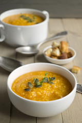 Vegetarian pumpkin soup on a wooden table.
