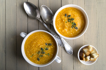 Vegetarian pumpkin soup on a wooden table.