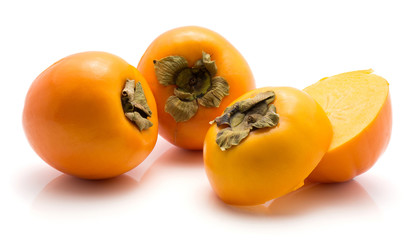 Persimmon Kaki isolated on white background two whole two sliced halves.