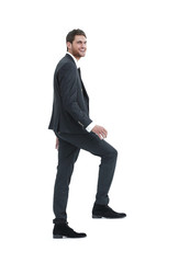 full growth.businessman taking a step forward.isolated on white.