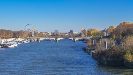 Paris, pont Alexandre III, bridge on the Seine, with the big wheel attraction in background
