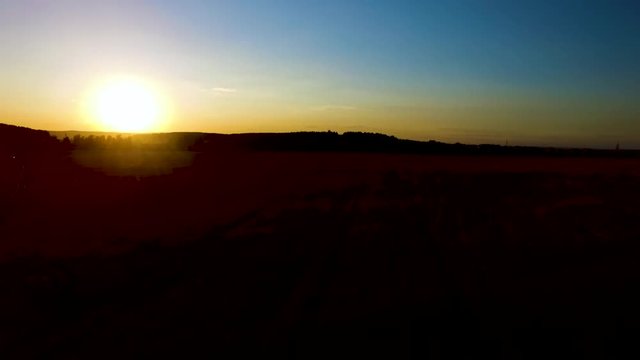 Beautiful aerial view from drone Sugar cane field with sunset sky nature landscape background. Majestic sunset in the nature landscape. Aerial panorama of summer nature landscape.